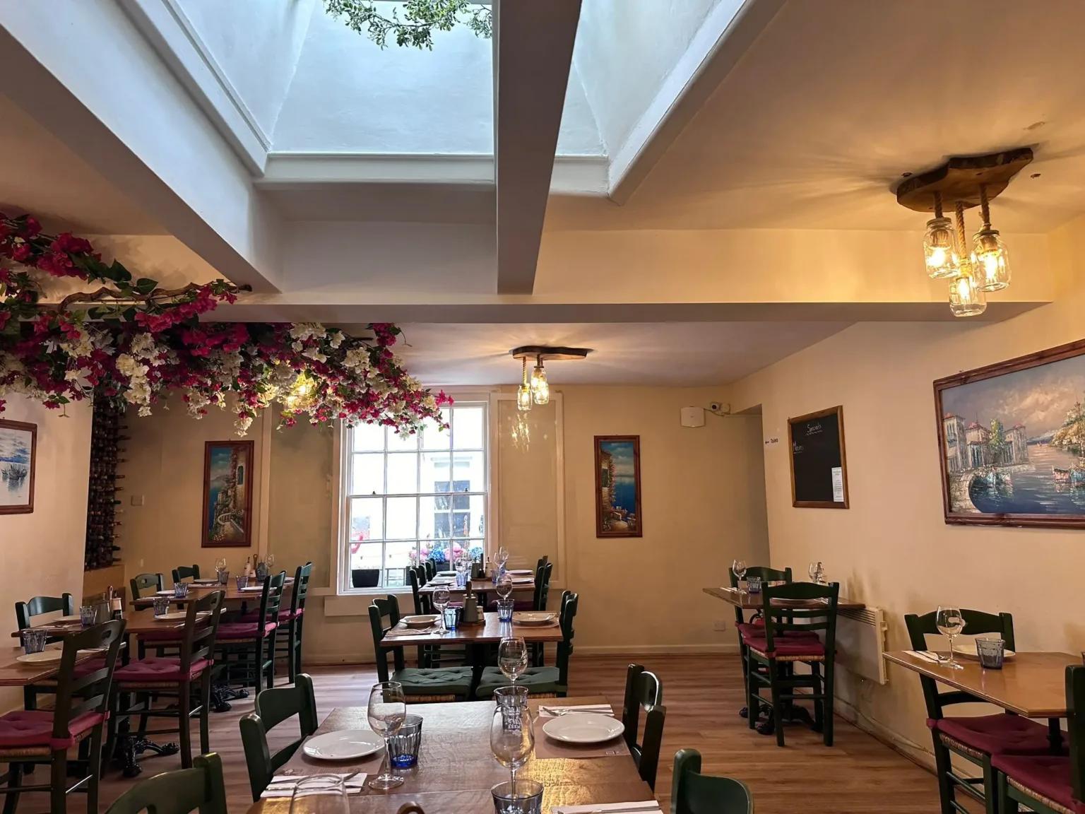 A wider, bustling view of the Jars Meze dining room with happy guests seated and enjoying their dinner service.